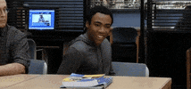 TV gif. Donald Glover as Troy in Community grins while rolling his shoulder back and giving a theatrical thumbs-up.