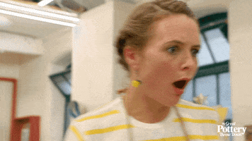 Reality TV gif. Blonde-haired contestant on The Great Pottery Throw Down gapes with shock or anger, her brow furrowed and her mouth open, and turns around.