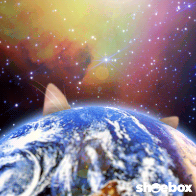 Digital art gif. A massive orange tabby cat in outer space peaks its curious head over the planet Earth. 