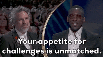 Oscars 2024 GIF. Split screen of Mark Ruffalo pensive and attentive as Mahershala Ali tells him, “Your appetite for challenges is unmatched.”