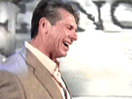 Celebrity gif. Vince McMahon holds his head back and lets out a hearty laugh as if he’s greatly amused.