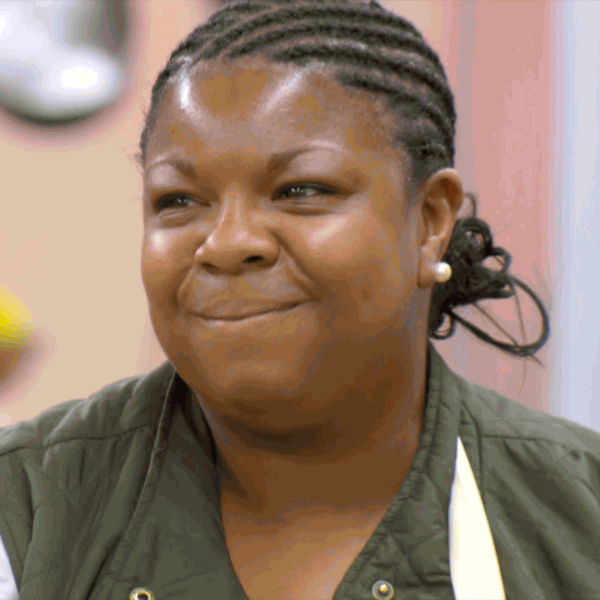 Reality TV gif. A contestant on The Great British Baking Show grimaces at her evaluation.