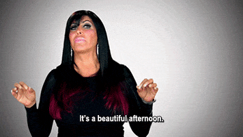 Reality TV gif. Big Ang on Mob wives talks and her hands are up, moving along with her words as she says, “It’s a beautiful afternoon.”