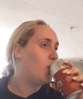Video gif. Tiktoker Brittany Broski cringing in disgust after taking a sip of Kombucha, contorting her face into a big frown. She quickly changes her tune as she thinks for a moment, then she goes back to being disappointed saying, “no, no,” and then thinks again about the taste. She tilts her head and chuckles, saying, “well…” 