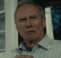 Movie gif. Clint Eastwood as Walt in Gran Torino frowns with a look of disgust, shaking his head.