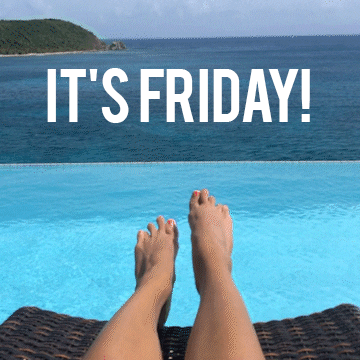 Video gif. We see a woman's feet as she lounges beside a pool that overlooks the ocean, wiggling her feet happily. Text, "It's Friday!"