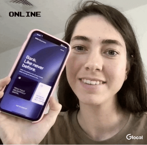 headliner Olga Nayda CEO of Glocal Holding smartphone with opened WIO Bank application