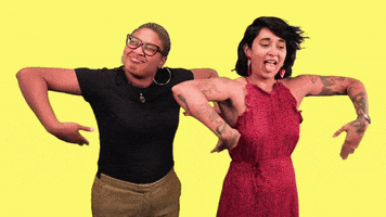 Video gif. Two women have their arms raised and they're manually fanning their pits with their hands, trying to beat the heat.