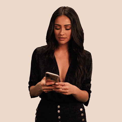 Video gif. Shay Mitchell reads aloud as she is texting someone. She then looks up at us with a dry, unamused expression. Text, "LOL."