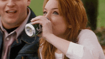 Celebrity gif. Lindsay Lohan drinks a can of Sprite and then does a spit take, sputtering it out.