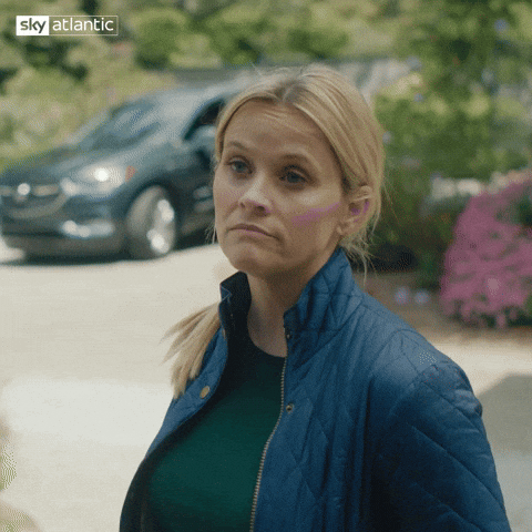 TV gif. Reese Witherspoon as Madeline Martha Mackenzie in Big Little Lies shrugs, her hands in her pockets, as if to say, "I don't really care."