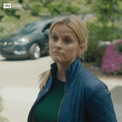 TV gif. Reese Witherspoon as Madeline Martha Mackenzie in Big Little Lies shrugs, her hands in her pockets, as if to say, "I don't really care."