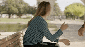 TV gif. Mélanie Maudran as Claire in Un Si Grand Soleil. She's sitting on a bench and is turned away from us. She slumps forward and puts her head in her hands, giving up.