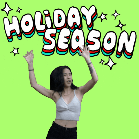 Video gif. Young woman shakes and dances on a lime green background, arms in the air, under big sparkly white bubble letters echoed in red and green that read, "Holiday season."