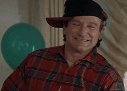 Movie gif. A laughing Robin Williams wears a plaid red flannel and a black baseball cap to one side. He adopts a different persona to ask us: Text, "Wazzup?"