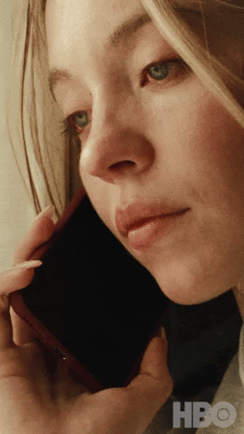 TV gif. Sydney Sweeney as Cassie in Euphoria, phone to her ear, asos "Really? What'd he say?"