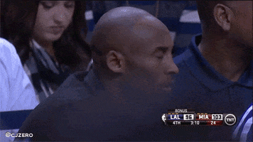 Sports gif. Kobe Bryant watching a game and shaking his head, deeply disappointed and scratching his head.