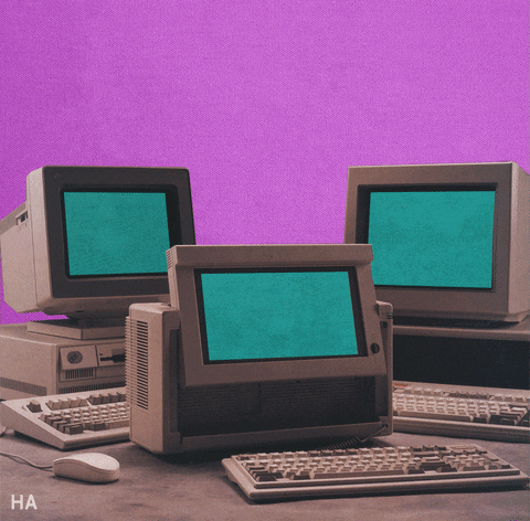 Digital compilation gif. Three vintage 1980s HP computers sit on a desk in front of a purple background. An orange and yellow stitch travels across the frame from computer to computer as the screens reveal a thumbs up, okay, and heart symbol on the screens.