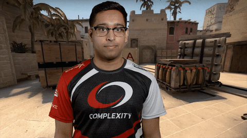 man in tshirt with complexity gaming logo pointing towards the logo on his tshirt