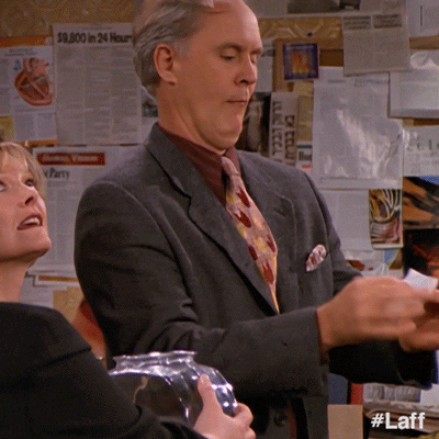 TV gif. John Lithgow as Dick in 3rd Rock from the Sun peaks at a scrap of paper in his hands then glances over teasingly at a woman by his side. 