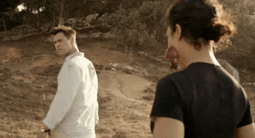 Movie gif. Chris Hemsworth as Agent H in Men in Black International turns back with a stern expression as he gives a firm thumbs up to Tessa Thompson as Molly. She purses her lips with a return thumbs up.