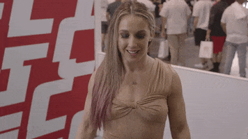Sports gif. Martial artist Vanessa Demopoulos excitedly points at the floor in front of her.