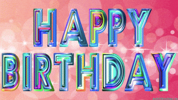 Text gif. Rainbow text fading into different colors, on a pink background, says "Happy birthday."