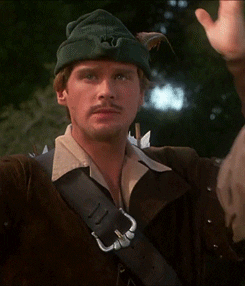 Movie gif. Cary Elwes as Robin in Robin Hood Men in Tights rolls his eyes and smashes his green feathered cap on his head as if in disbelief. 