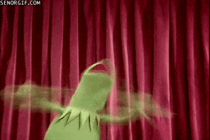 Muppets gif. Kermit the Frog stands in front of red stage curtains and frantically applauds, his green arms becoming a blur of motion.