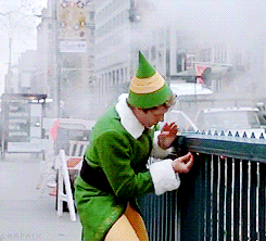 Gif of Will Ferrel in the movie Elf picking gum off of a subway entrance railing.