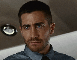 Celebrity gif. Jake Gyllenhaal as Colter Stevens in Source Code looks skeptical about something he's hearing and gently but firmly shakes his head no, closing one eye slightly as he does so.