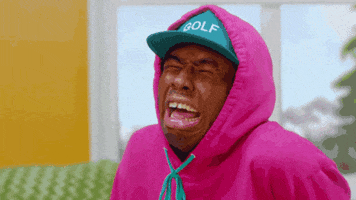 Celebrity gif. Tyler, the Creator is faux sobbing and his face is turned upwards at us while he pretends to cry like a baby.