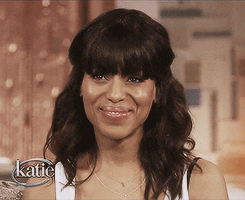 Celebrity gif. Kerry Washington scrunches her nose and smiles, then cups her hands at her mouth 