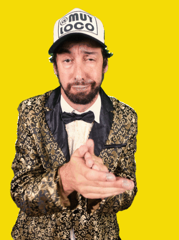 Video gif. Against a flashing yellow background, wearing a trucker hat and a shiny gold jacket, a bored-looking man with a beard claps at us.