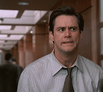 Movie gif. Jim Carrey as Fletcher Reede from Liar Liar clutches his face as he leans away in playful horror.