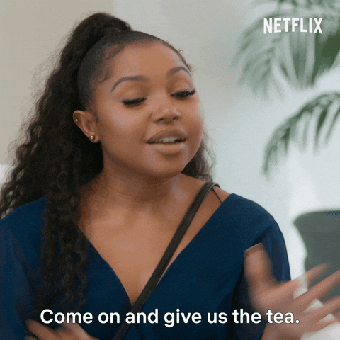 Reality TV gif. Anne-Sophie Petit from Selling Tampa waves her hands around and looks expectant as she asks, "What's the tea?"