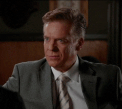 Celebrity gif. Christopher McDonald looking serious in a business suit and then cracking up with absurdity.