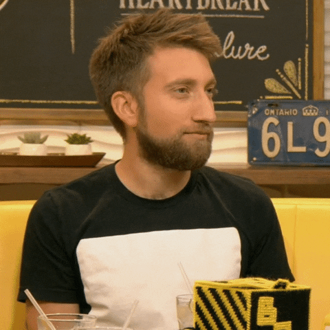 Video gif. Actor Gavin Free, wearing a black and white color-blocked t-shirt, says the word that appears as text, "samesies."