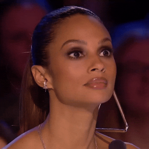 Reality TV gif. Close up on Alesha Dixon on Britain's Got Talent. She looks around with wide eyes, scared and confused at what will happen next.