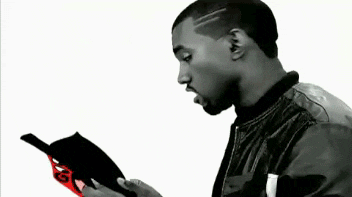 Celebrity gif. Text adds dashes of vibrant color to a black and white video of Kanye West shrugging. He unapologetically says, "Sorry," which appears as funky pink text in the shape of a speech bubble, and he holds a book that reads, "Sorry Censored" in animated white and red text.