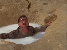 Movie gif. Scene from Honey I Shrunk the Kids where Nick Szalinski, played by Robert Oliveri, yells for help while clinging to the sides of a single Cheerio, bobbing in milk.