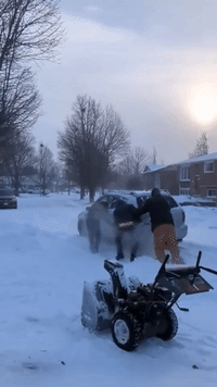 Residents Help Car Stuck on Snowy Road