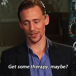 Celebrity gif. Tom Hiddleston shakes his head and smiles slightly as he says "get some therapy, maybe?" which appears as text.