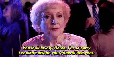 Movie gif. Betty White as Grandma Bunny from You Again at a party among flashing lights and dancing people, with a harsh facial expression. Text, "You look lovely, Helen. I'm so sorry I couldn't attend your funeral last year."