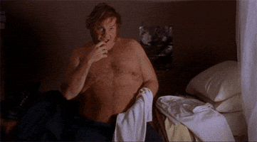 Movie gif. Chris Farley in Billy Madison without a shirt on, biting his finger and shrugging suggestively.