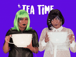 Video gif. Two women hold very large tea cups with both hands. They look at each other with big, wide eyes, and smirks on their faces. They both lift the tea cups to their faces to take sips out of them. Text, “Tea time.”
