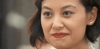 Reality TV gif. Stephanie Chen in The Great American Baking Show cracks a wide smile.