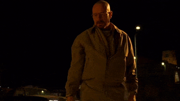 TV gif. Bryan Cranston as Walter White in Breaking Bad looks menacing as he stares someone down and breathes heavily through his mouth. It's a cold night and we see the vapor coming from his mouth as he says, "Run."