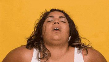 Video gif. Woman's head is leaned back in pleasure, her eyes closed and mouth open.