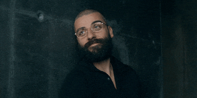 Movie gif. Oscar Isaac as Nathan in Ex Machina leans against a concrete wall, nodding and holding a beer up, as he says, “Dude. Cheers.”